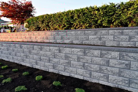 Block stone retaining wall in garden landscape